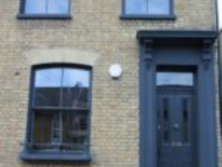 London Property with dark wood sash windows and door